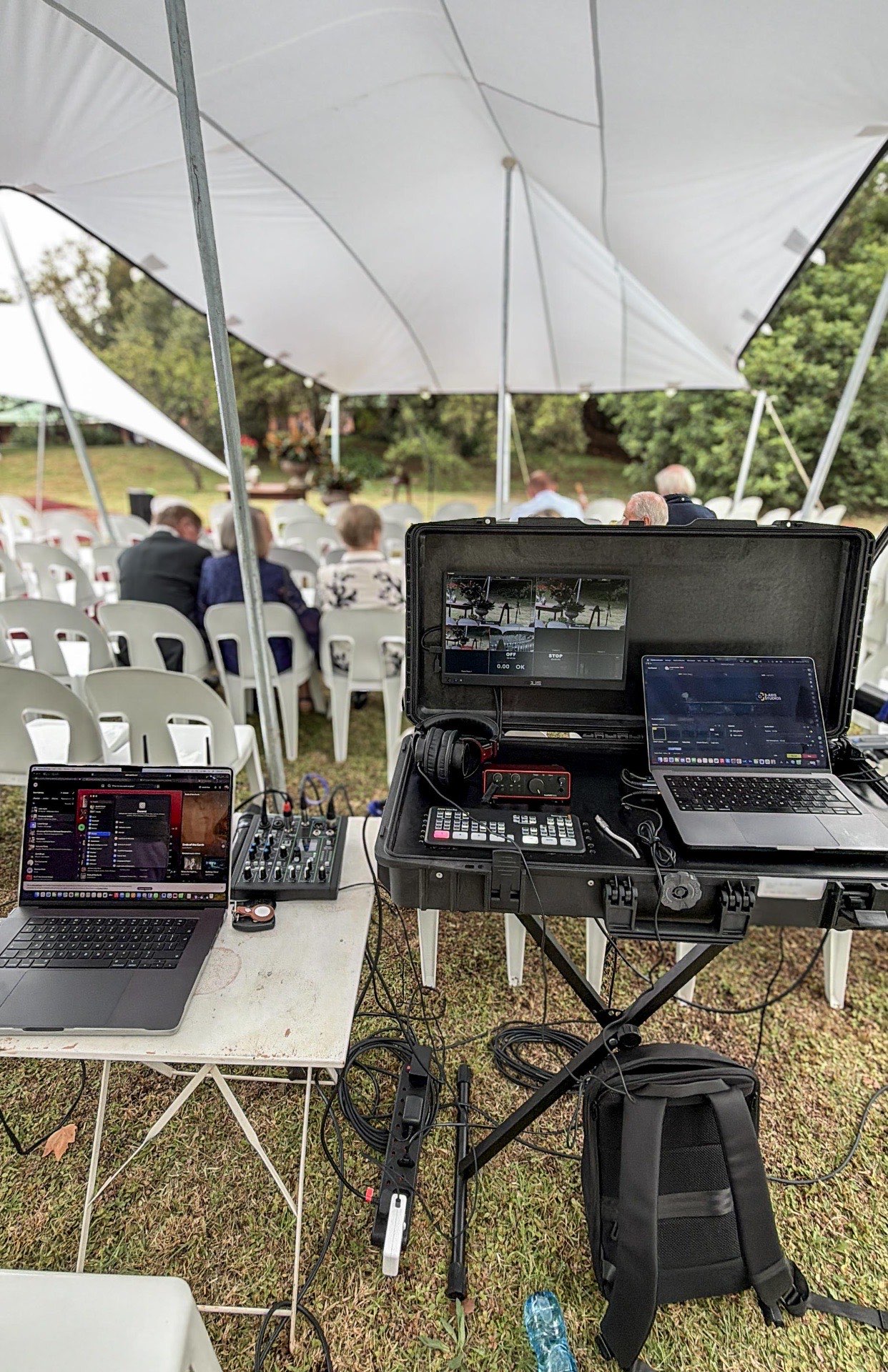 Live streaming setup at outdoor memorial under tent