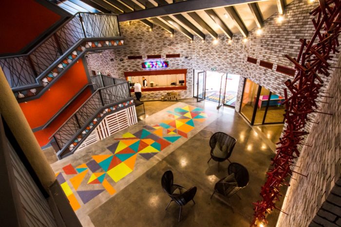 Interior venue photography — lobby with staircase and colourful geometric floor