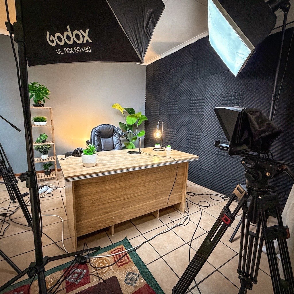 Softbox LED lighting aimed at the presenter desk in the 3-Axis studio, with acoustic foam wall