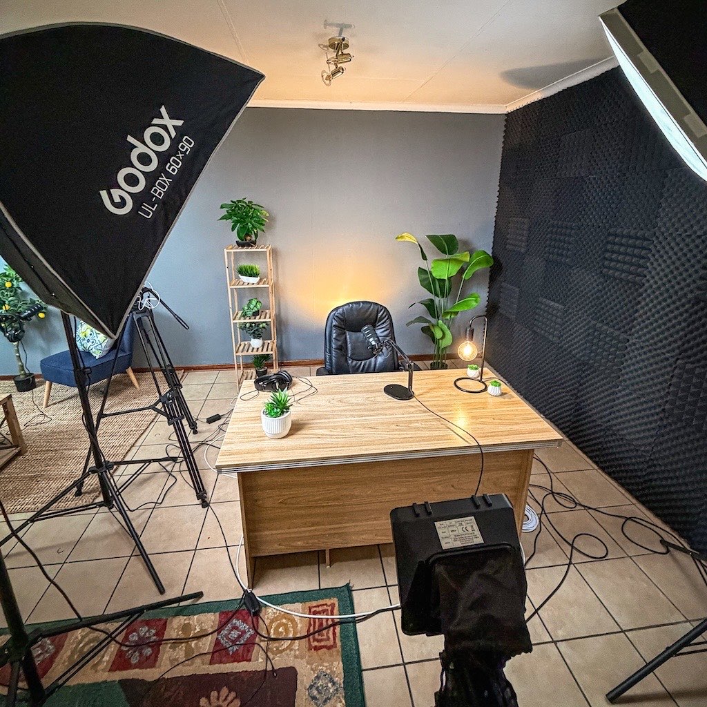 Presenter desk with microphone seen from behind the teleprompter camera in the 3-Axis studio