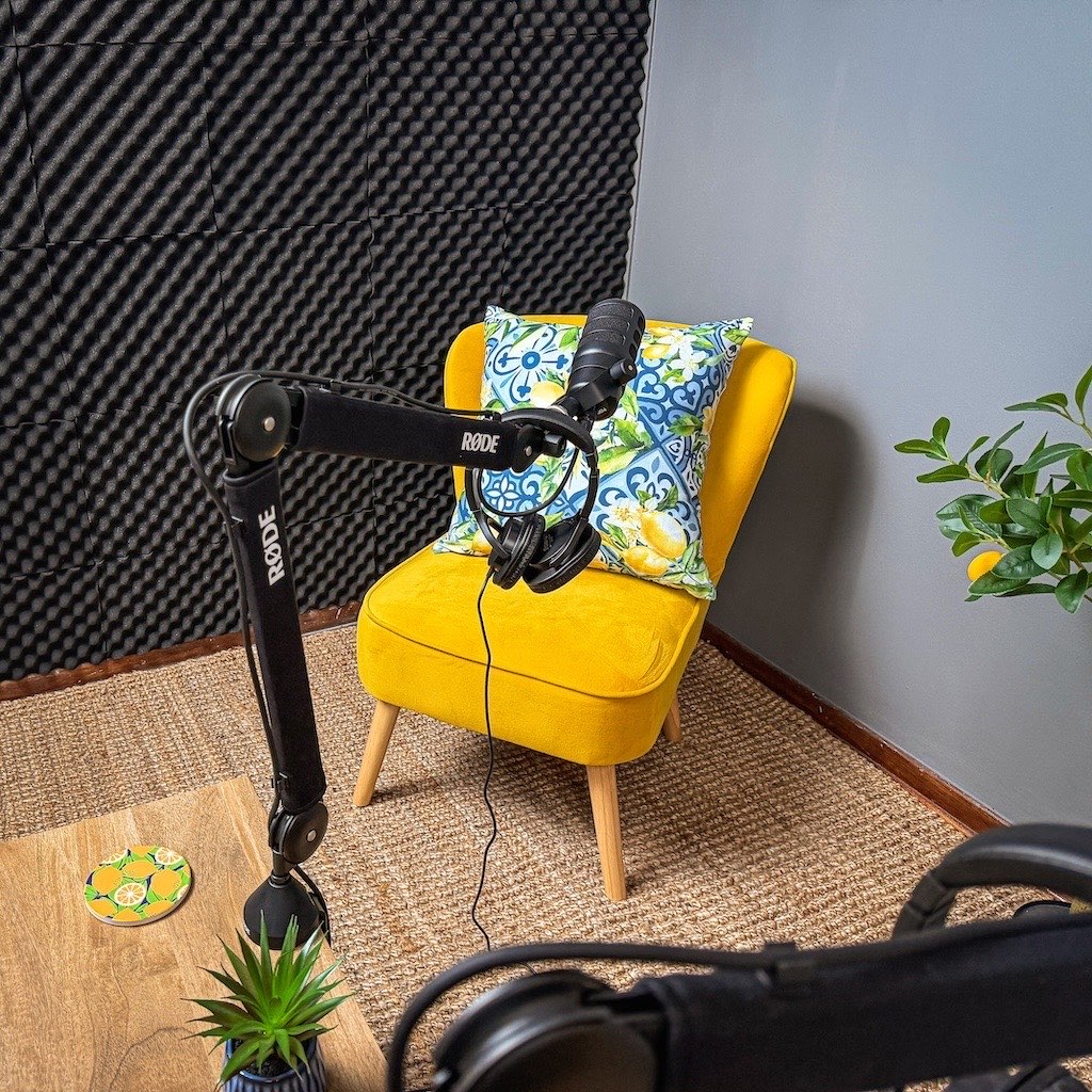 Yellow guest armchair with microphone and headphones against the acoustic foam wall