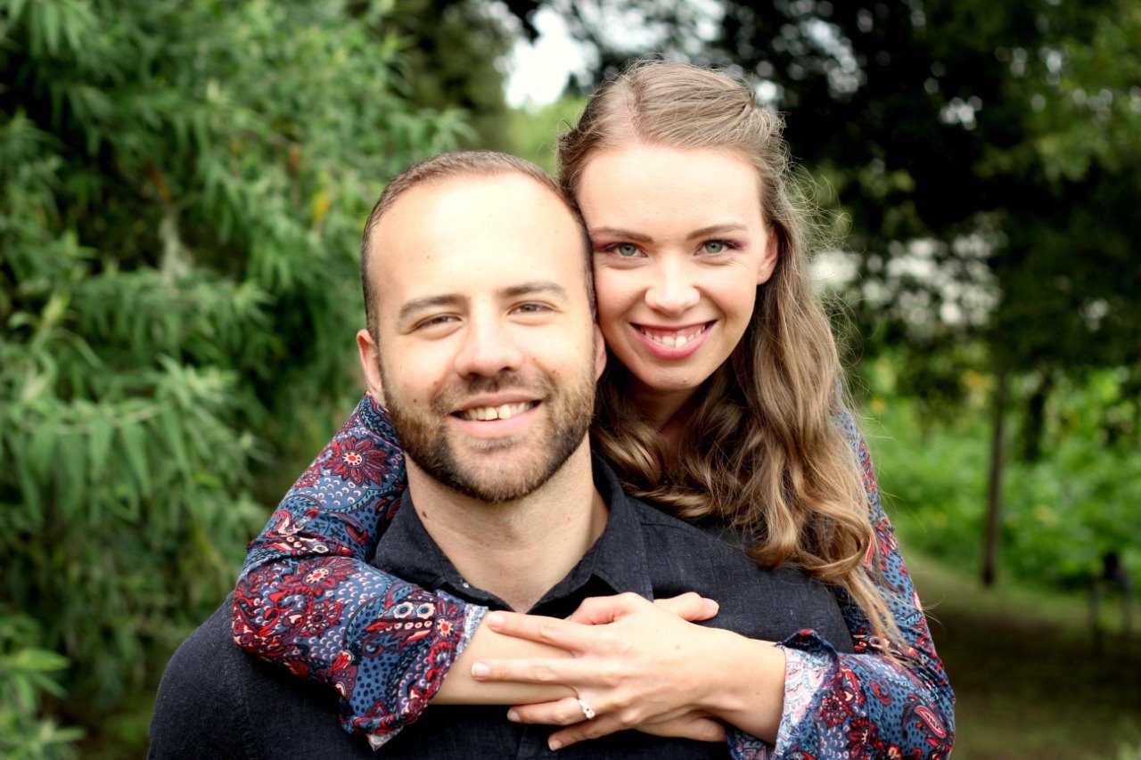 Engaged couple embracing outdoors in an engagement portrait